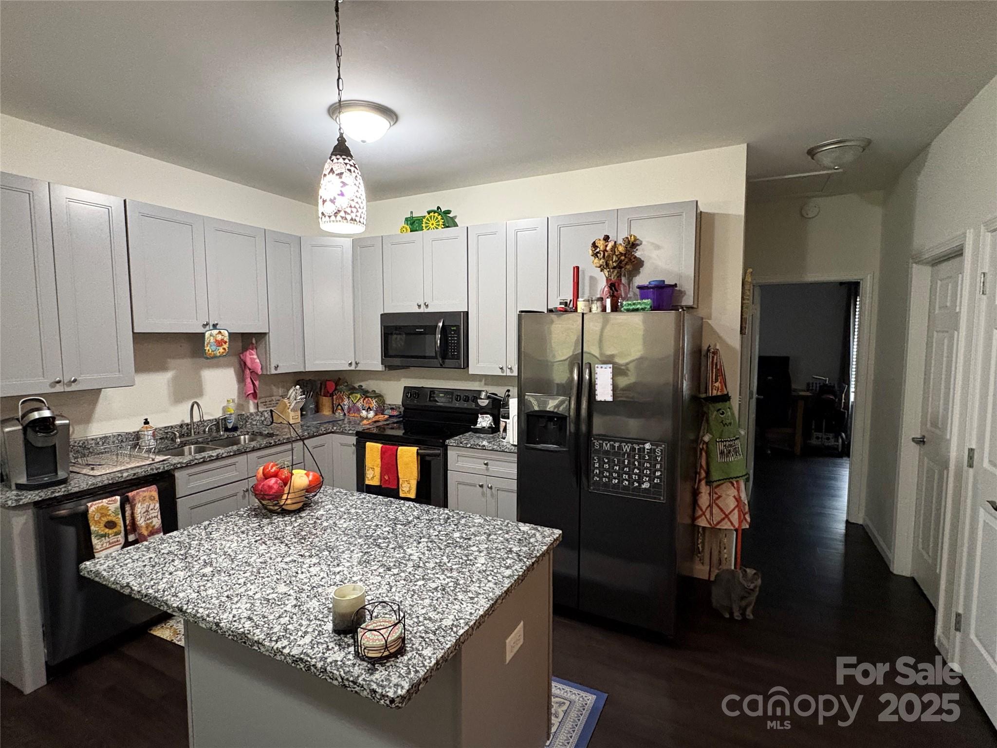 10 Scarlett Ridge Drive Marshall, NC 28753 - Photo 19 of 31 a kitchen with stainless steel appliances granite countertop a refrigerator a stove top oven a sink dishwasher and microwave with wooden floor