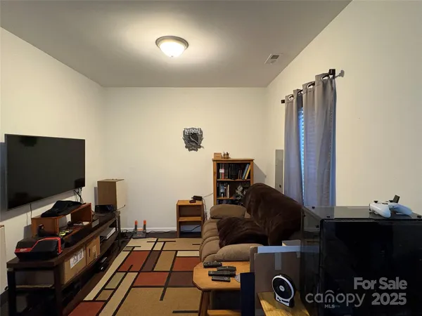 a room with furniture and flat screen tv