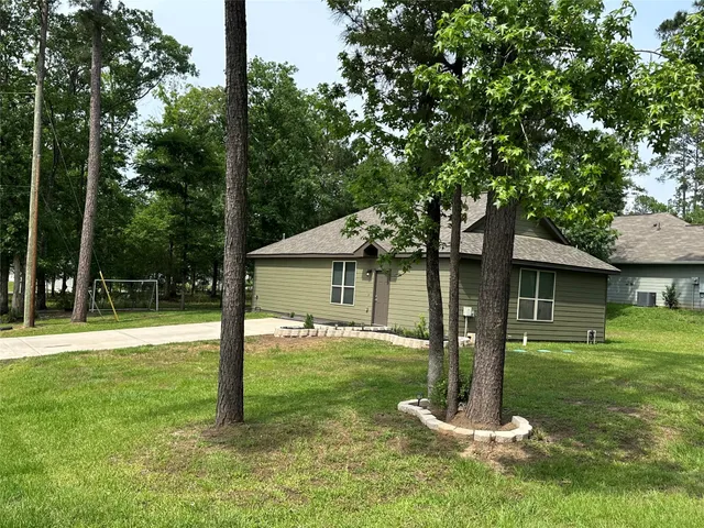 a front view of house with a garden