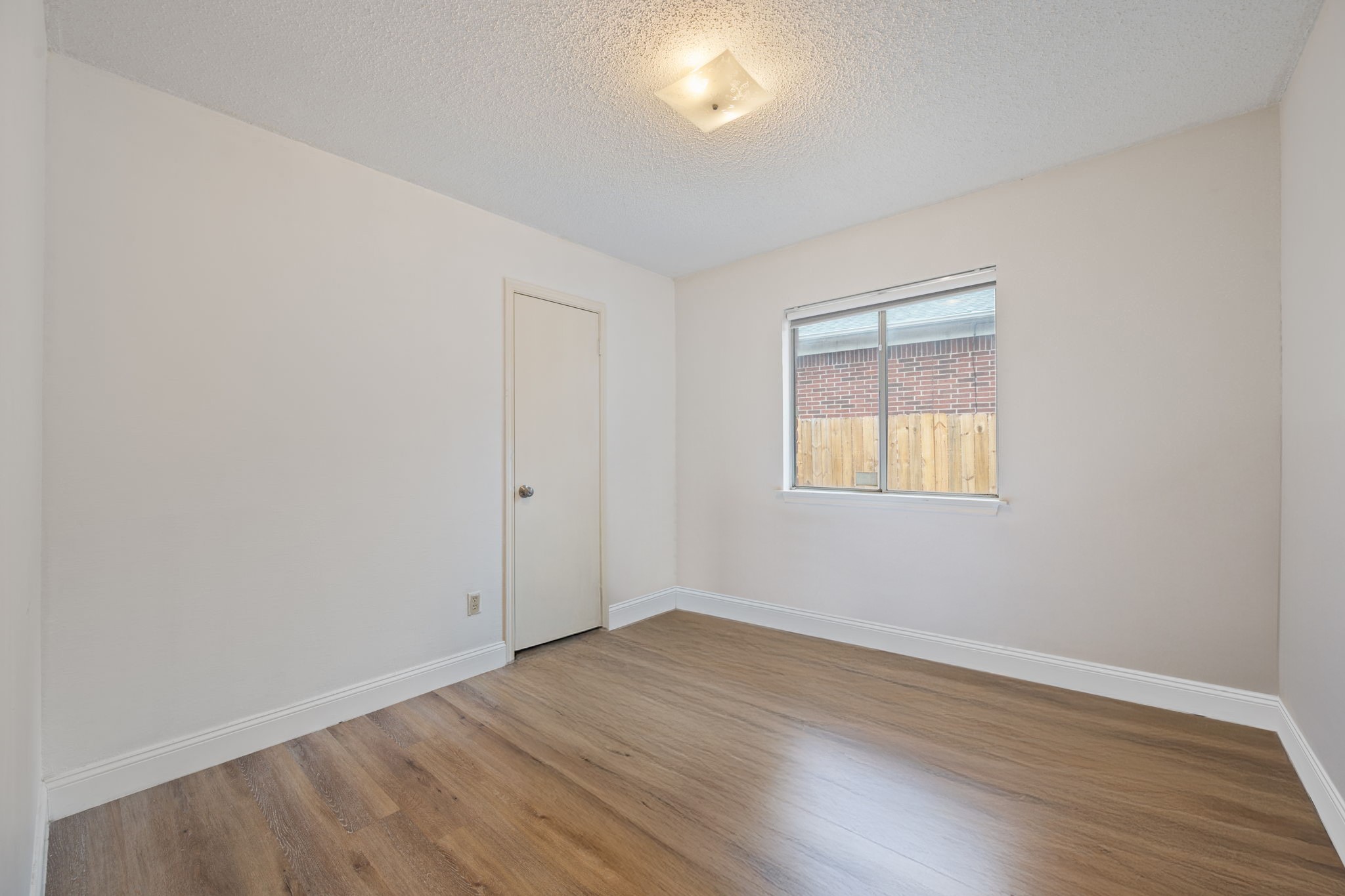 12501 Fallen Tower Lane Austin, TX 78753 - Photo 25 of 31 an empty room with wooden floor and windows