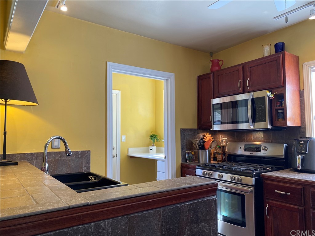 7548 Security Avenue Burbank, CA 91504 - Photo 19 of 41 a kitchen with stainless steel appliances granite countertop a stove a sink and a microwave