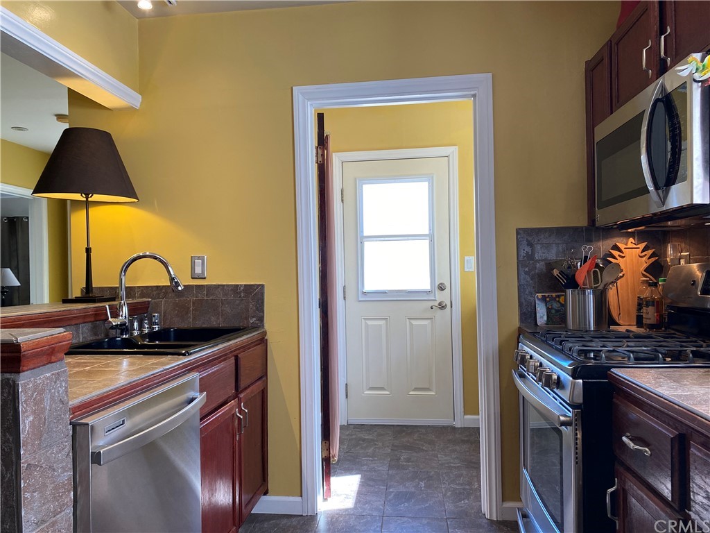 7548 Security Avenue Burbank, CA 91504 - Photo 20 of 41 a kitchen with a sink a stove and cabinets