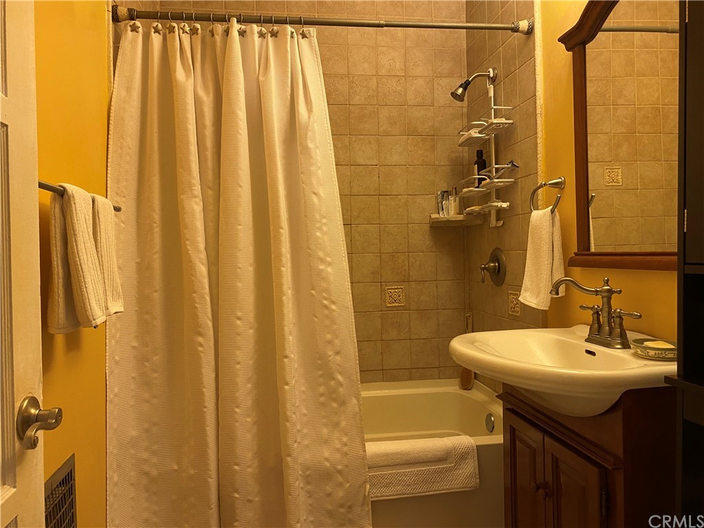 7548 Security Avenue Burbank, CA 91504 - Photo 30 of 41 a bathroom with a sink a mirror and a shower