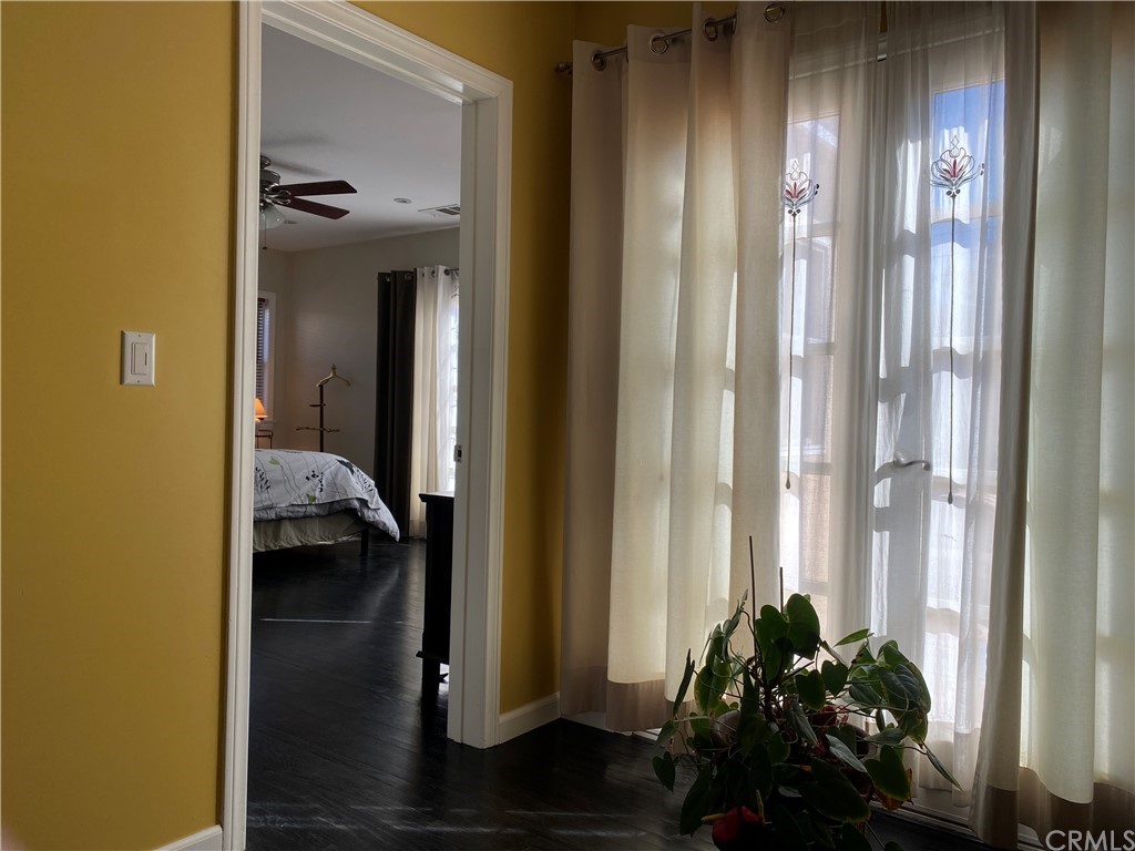 7548 Security Avenue Burbank, CA 91504 - Photo 32 of 41 a view of a hallway with wooden floor and a bedroom