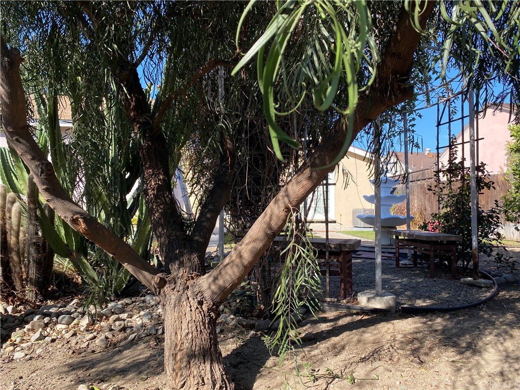 7548 Security Avenue Burbank, CA 91504 - Photo 8 of 41 a backyard of a house with table and chairs under an umbrella