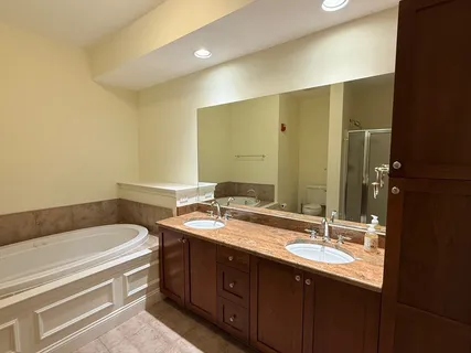 a bathroom with a double vanity sink and a mirror