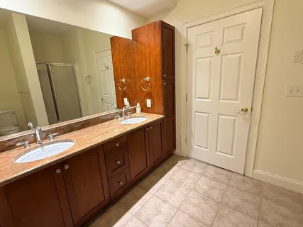 a bath room with a sink and a mirror