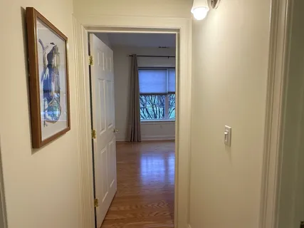 a view of a hallway with wooden floor