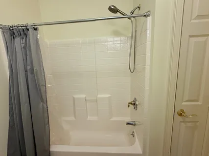 a bathroom with a shower and a glass door shower