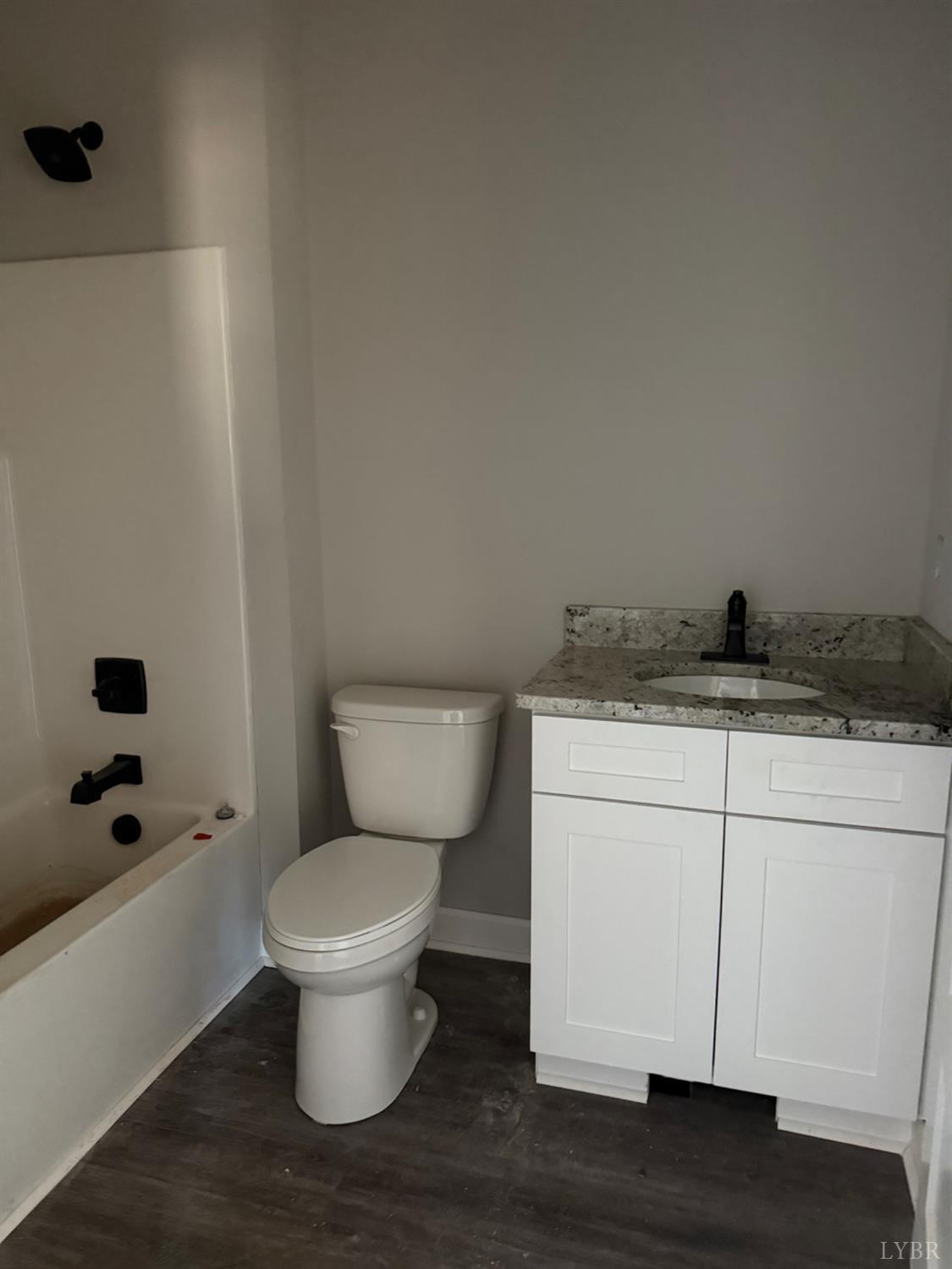 209 Spicer Road Lynchburg, VA 24504 - Photo 11 of 13 a bathroom with a granite countertop toilet and a sink