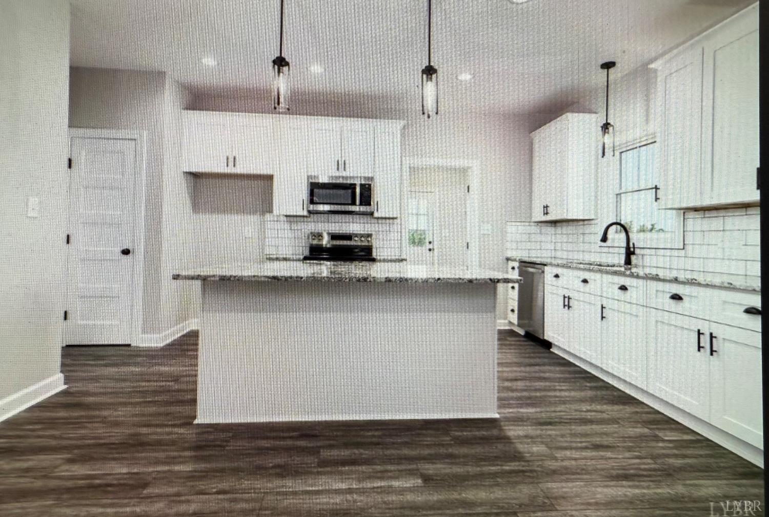 209 Spicer Road Lynchburg, VA 24504 - Photo 4 of 13 a large kitchen with stainless steel appliances kitchen island a white cabinets and wooden floor