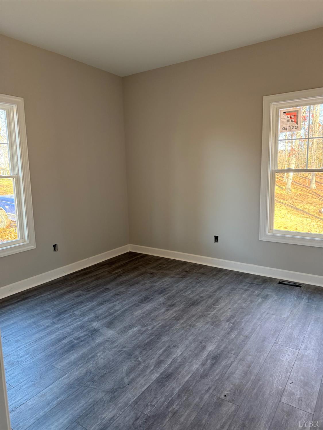 209 Spicer Road Lynchburg, VA 24504 - Photo 7 of 13 a view of an empty room with wooden floor and a window