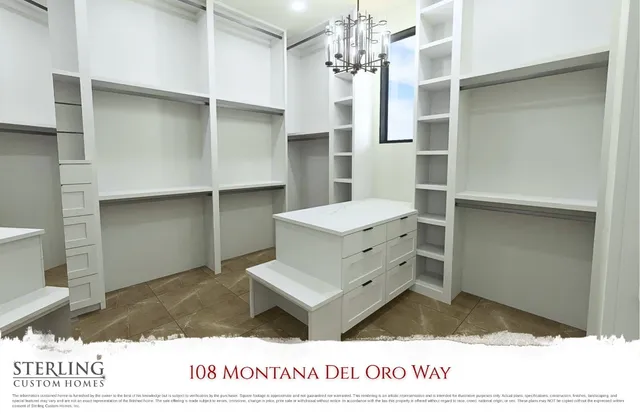 a living room with a bed furniture and a chandelier