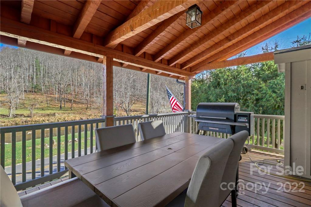 431 Silas Creek Road, Unit 4 Lansing, NC 28643 - Photo 18 of 46 a outdoor dining space with furniture and wooden floor