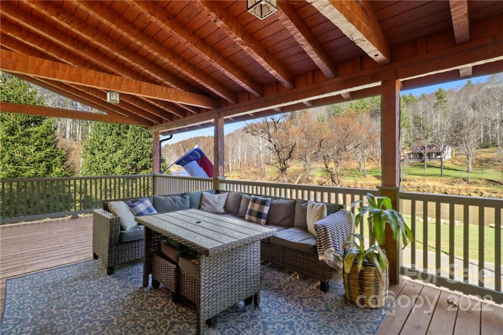 431 Silas Creek Road, Unit 4 Lansing, NC 28643 - Photo 3 of 46 a view of a wooden deck with furniture and wooden floor