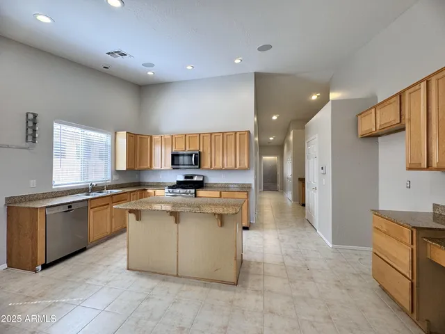 a large kitchen with stainless steel appliances lots of counter top space