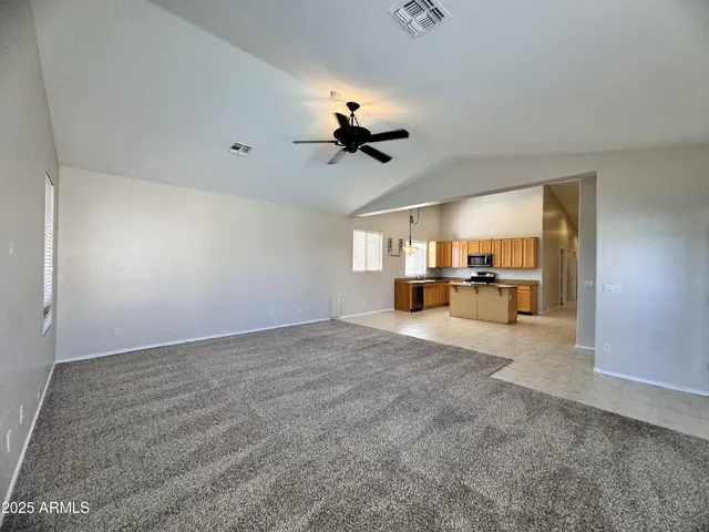 a view of a livingroom with furniture and a ceiling fan