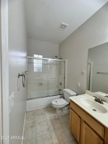 an empty room with a ceiling fan and window