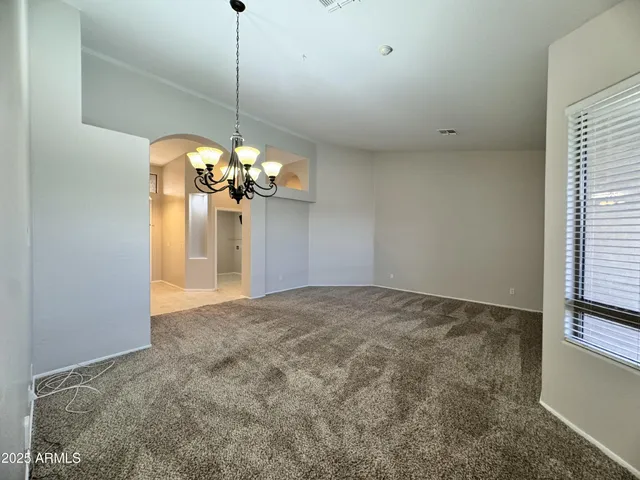 a view of a chandelier fan and refrigerator