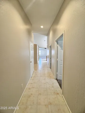 a view of a hallway with a bathroom