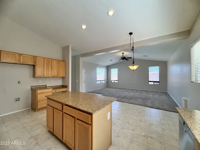 a kitchen with a stove kitchen island and a refrigerator