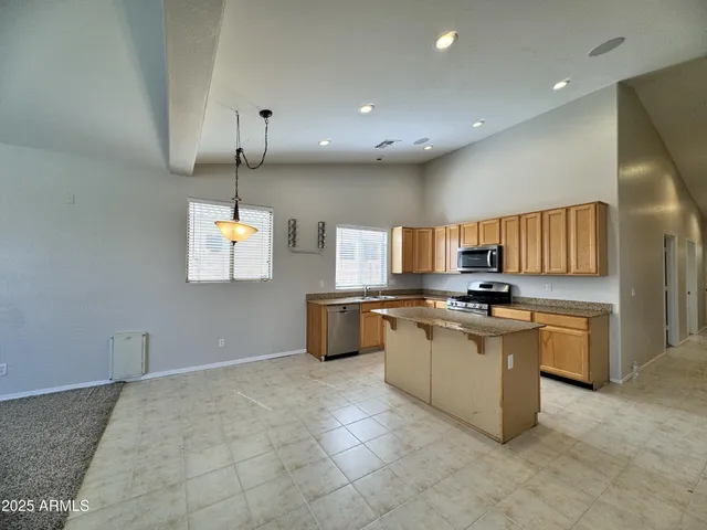 a large kitchen with a large counter top appliances and cabinets