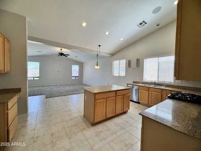 a kitchen with stainless steel appliances granite countertop a sink and a stove