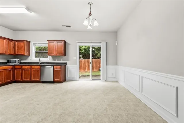 a large kitchen with stainless steel appliances granite countertop a stove and cabinets