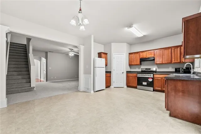 a kitchen with stainless steel appliances a refrigerator sink and stove