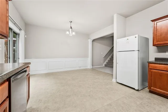 a view of kitchen with furniture and refrigerator