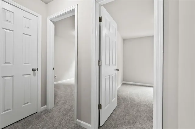 a view of a hallway with two rooms