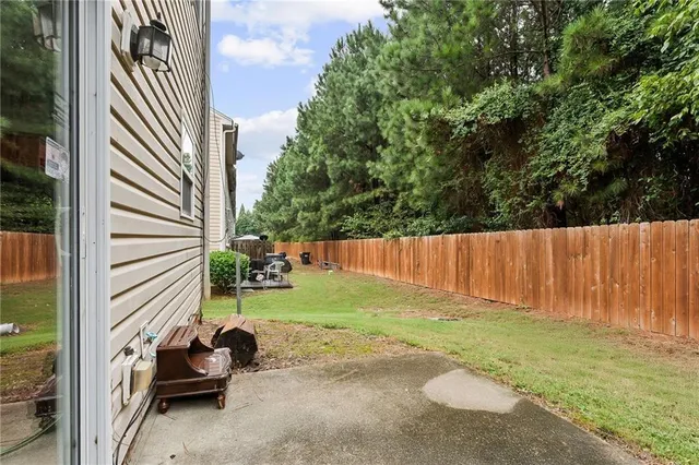 a backyard of a house with table and chairs