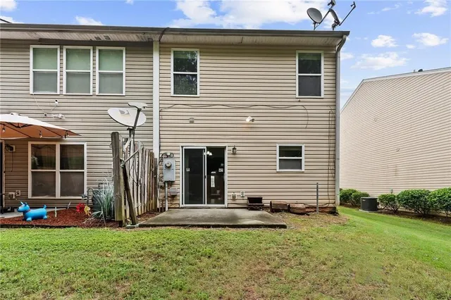 a view of a house with a yard and a car parked in front of it