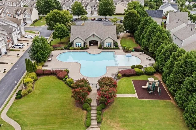 an aerial view of a house with yard swimming pool and outdoor seating