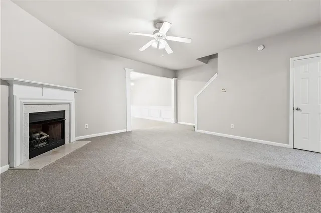 a view of an empty room with a fireplace