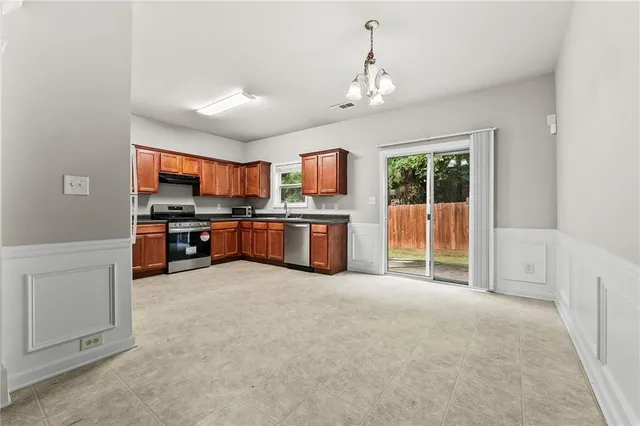 a large kitchen with cabinets and stainless steel appliances