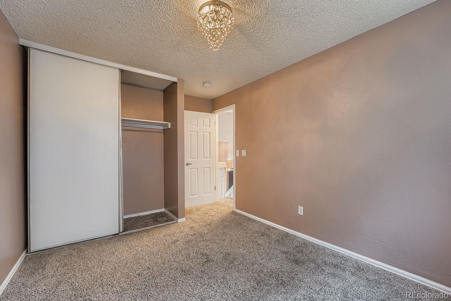 17365 East Rice Circle, Unit A Aurora, CO 80015 - Photo 12 of 18 a view of an empty room with a window