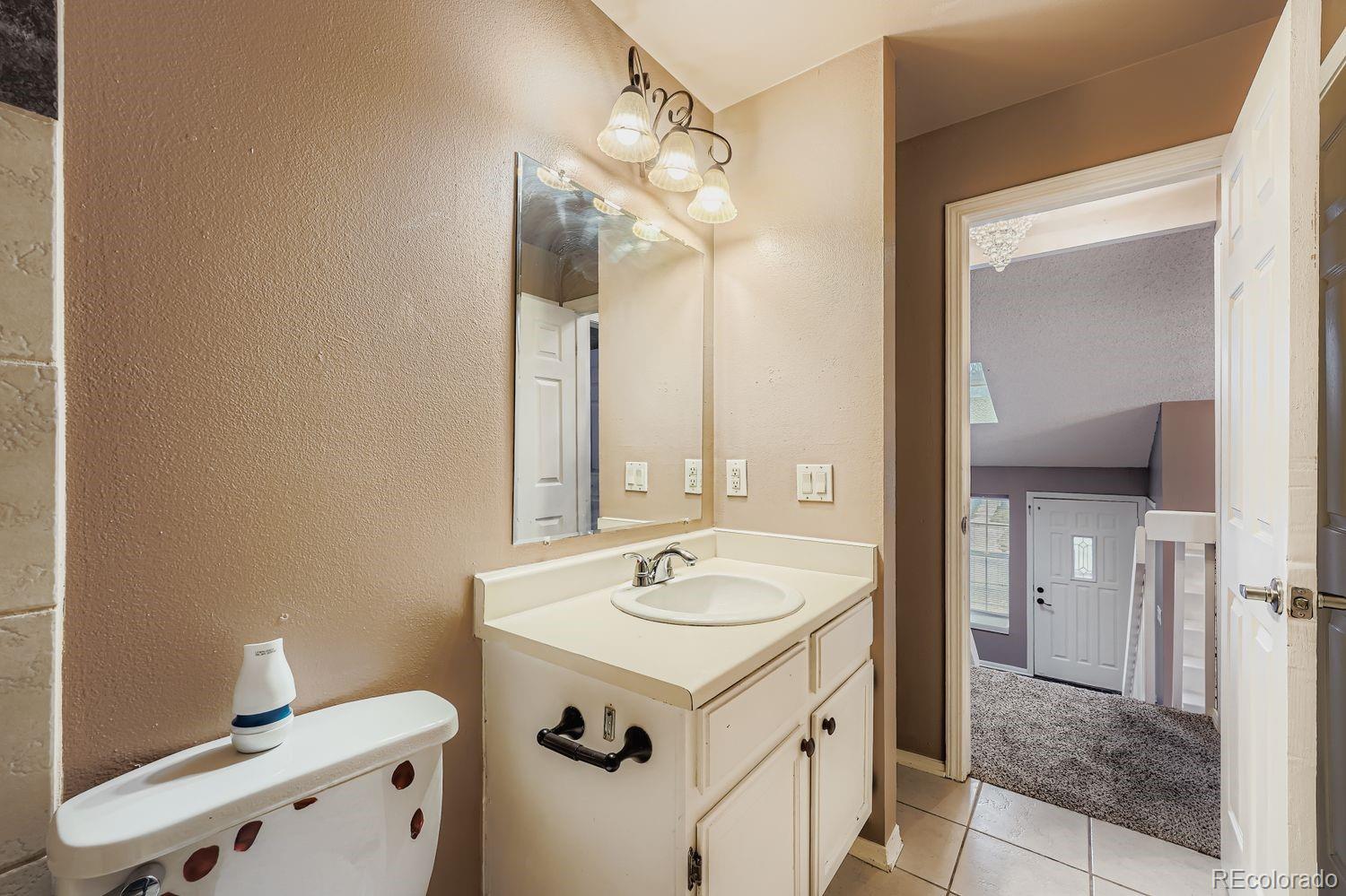 17365 East Rice Circle, Unit A Aurora, CO 80015 - Photo 14 of 18 a bathroom with a sink and a mirror