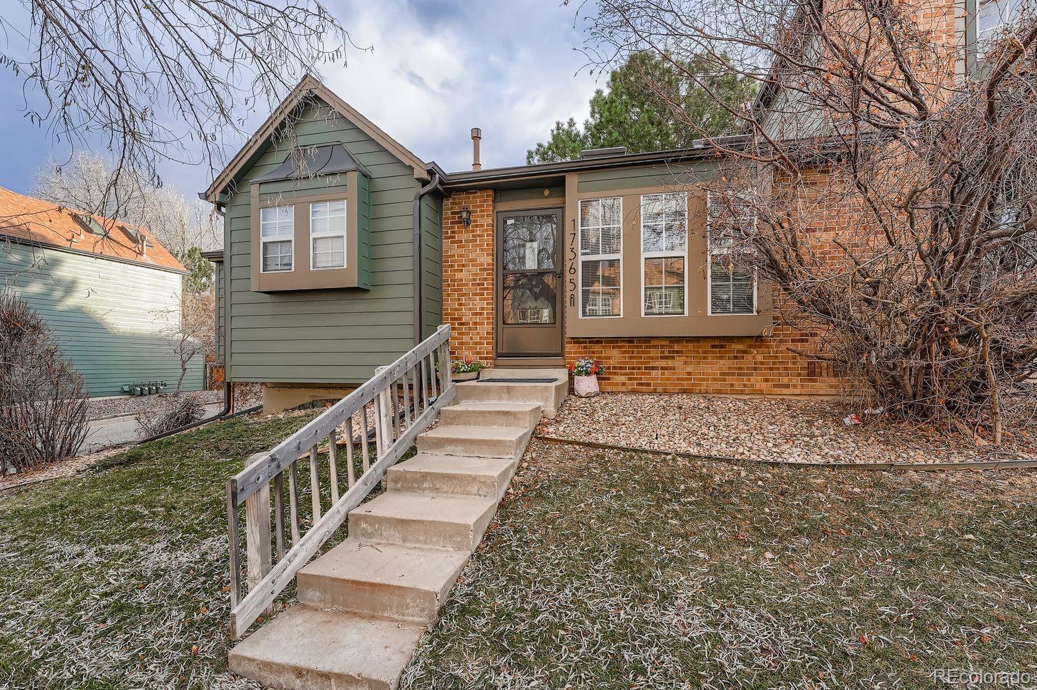 17365 East Rice Circle, Unit A Aurora, CO 80015 - Photo 15 of 18 a view of a brick house that has large windows