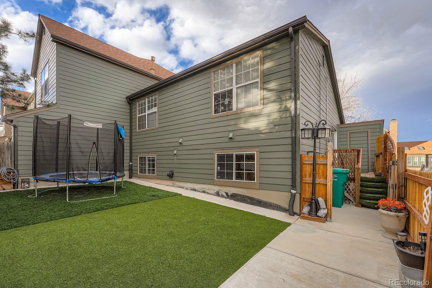 17365 East Rice Circle, Unit A Aurora, CO 80015 - Photo 17 of 18 a backyard of a house with barbeque oven and table and chairs