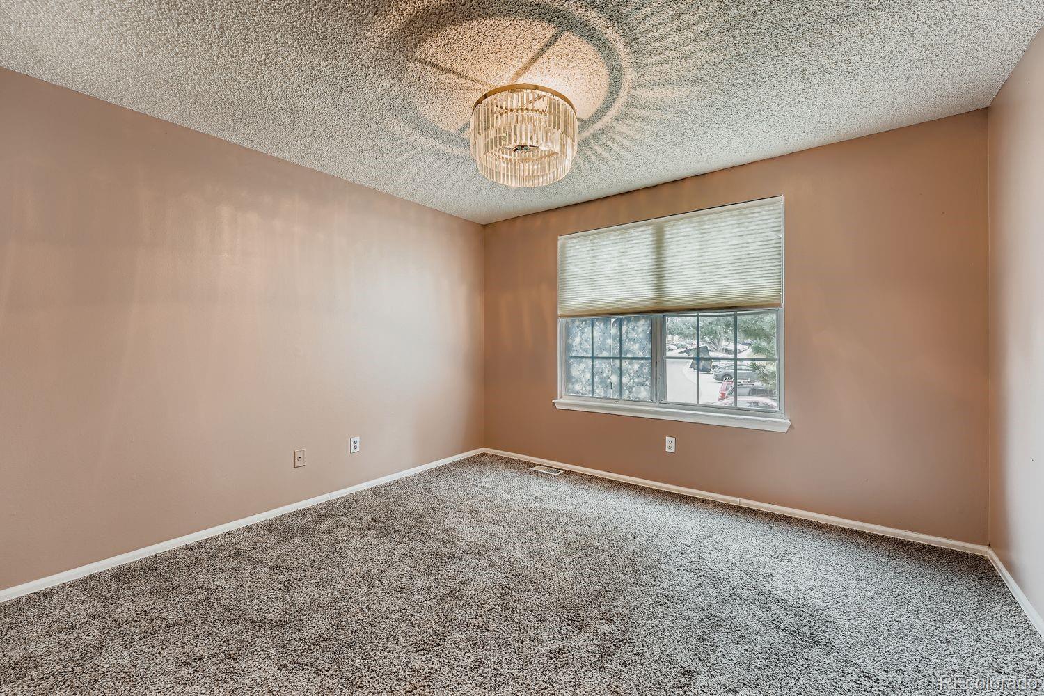 17365 East Rice Circle, Unit A Aurora, CO 80015 - Photo 7 of 18 an empty room with a window