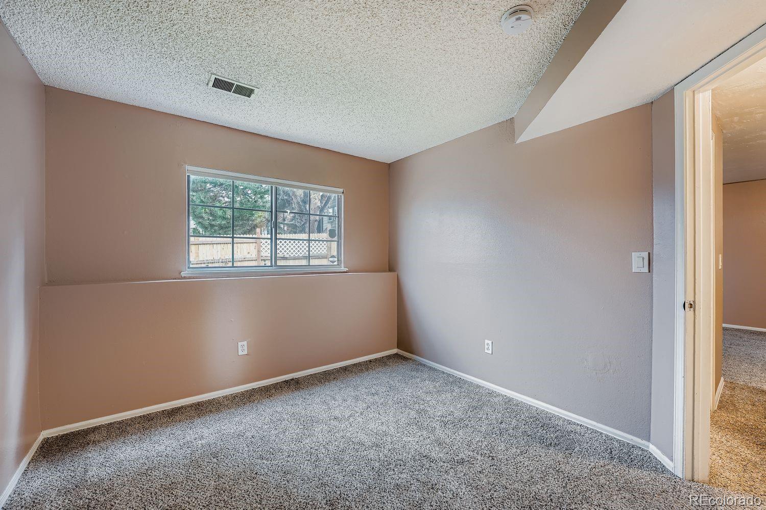 17365 East Rice Circle, Unit A Aurora, CO 80015 - Photo 8 of 18 an empty room with windows