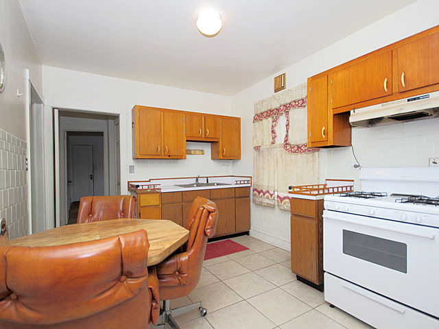 2005 Darrow Avenue Evanston, IL 60201 - Photo 11 of 24 a kitchen with stainless steel appliances granite countertop a stove a sink and a refrigerator