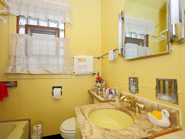 2005 Darrow Avenue Evanston, IL 60201 - Photo 9 of 24 a bathroom with a granite countertop toilet sink and mirror