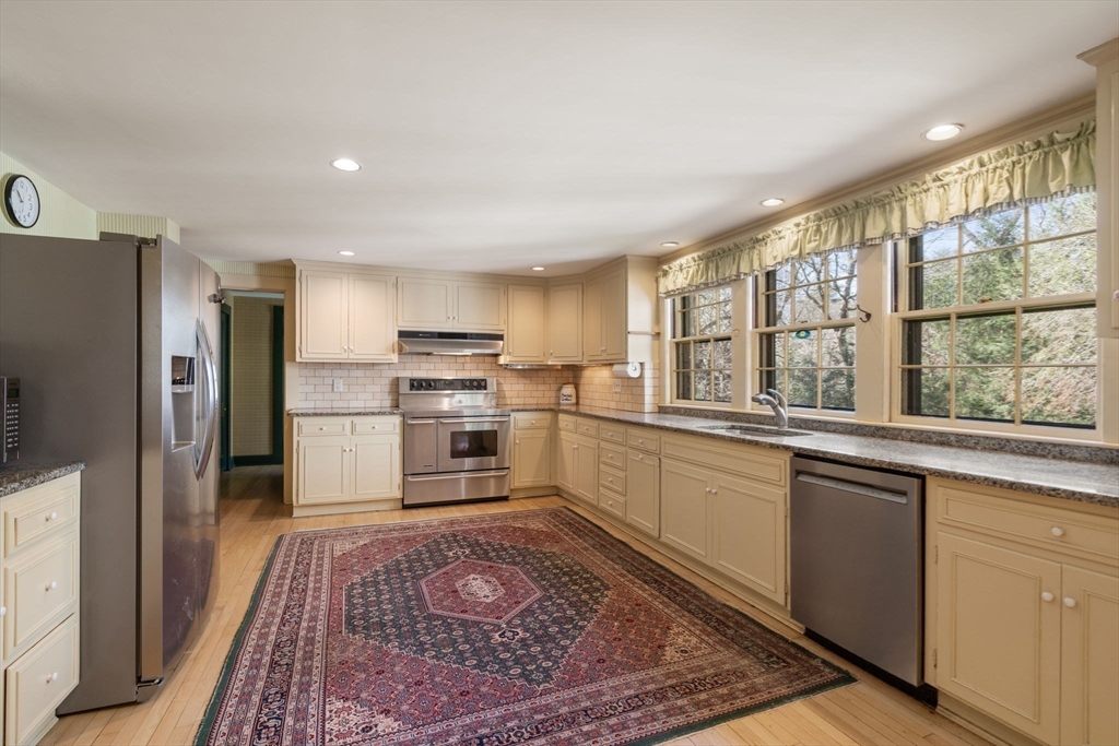 83 Webster Road Weston, MA 02493 - Photo 14 of 24 a kitchen with stainless steel appliances granite countertop a refrigerator sink and cabinets