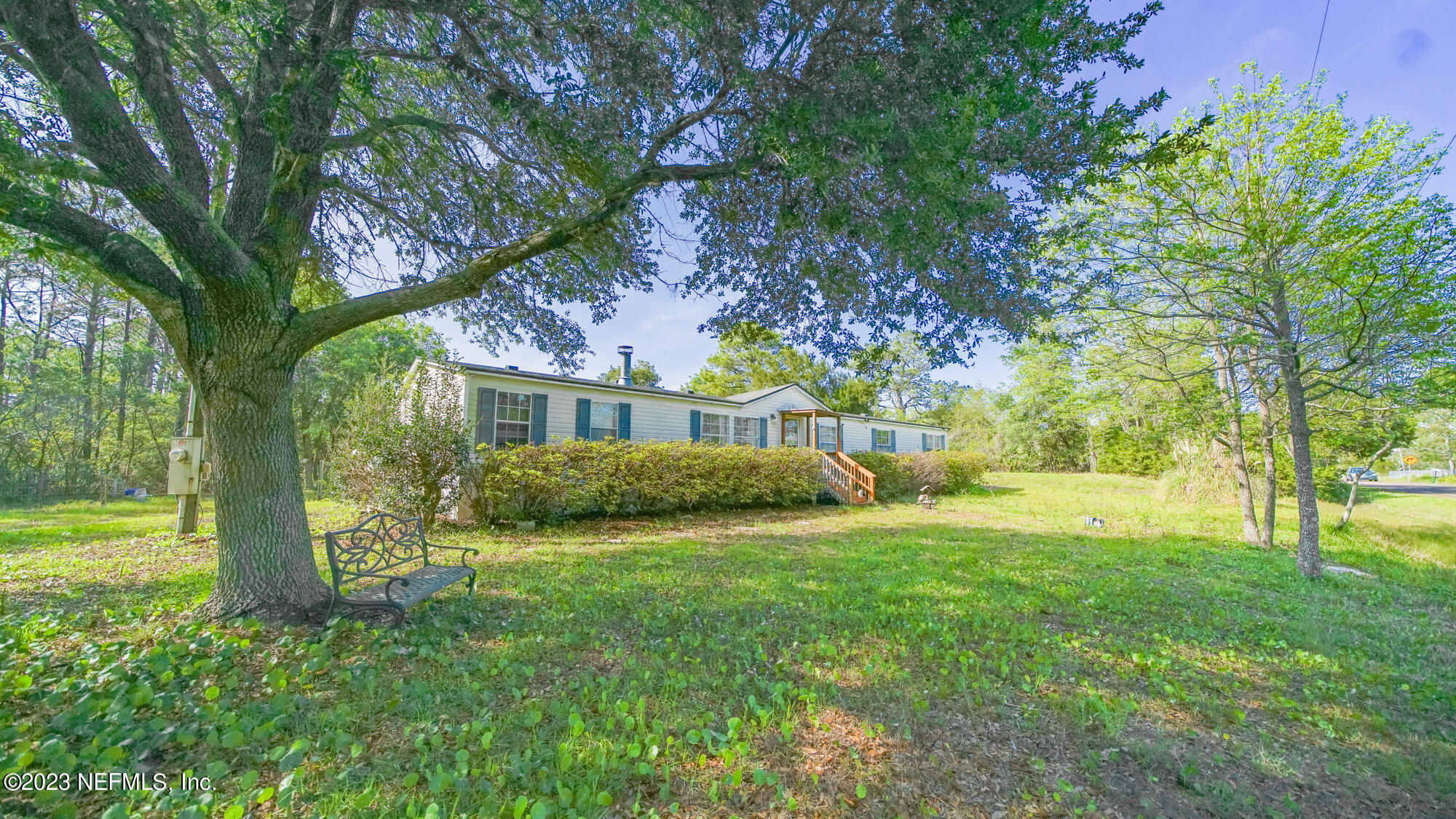 a view of house with backyard