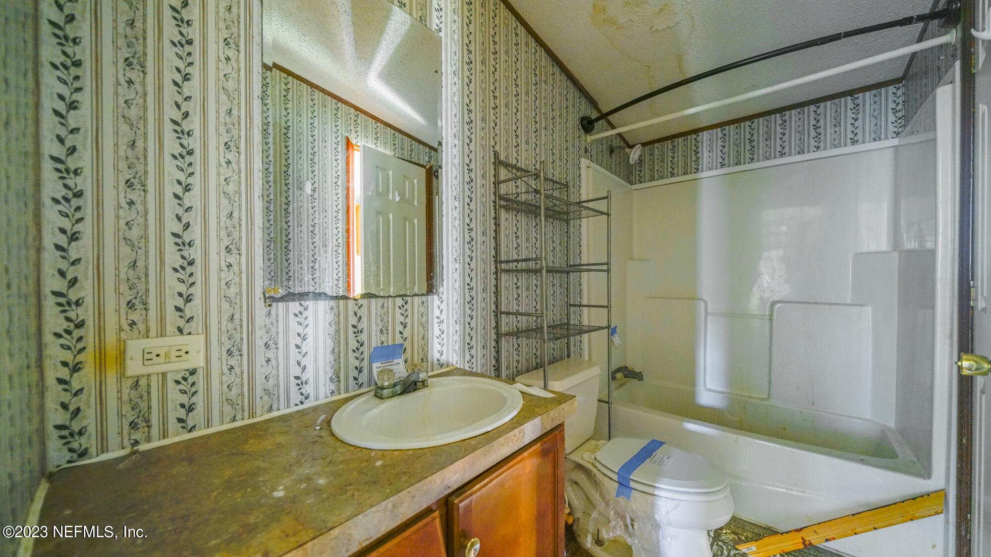 16055 Shellcracker Road Jacksonville, FL 32226 - Photo 14 of 32 a bathroom with a sink and a mirror