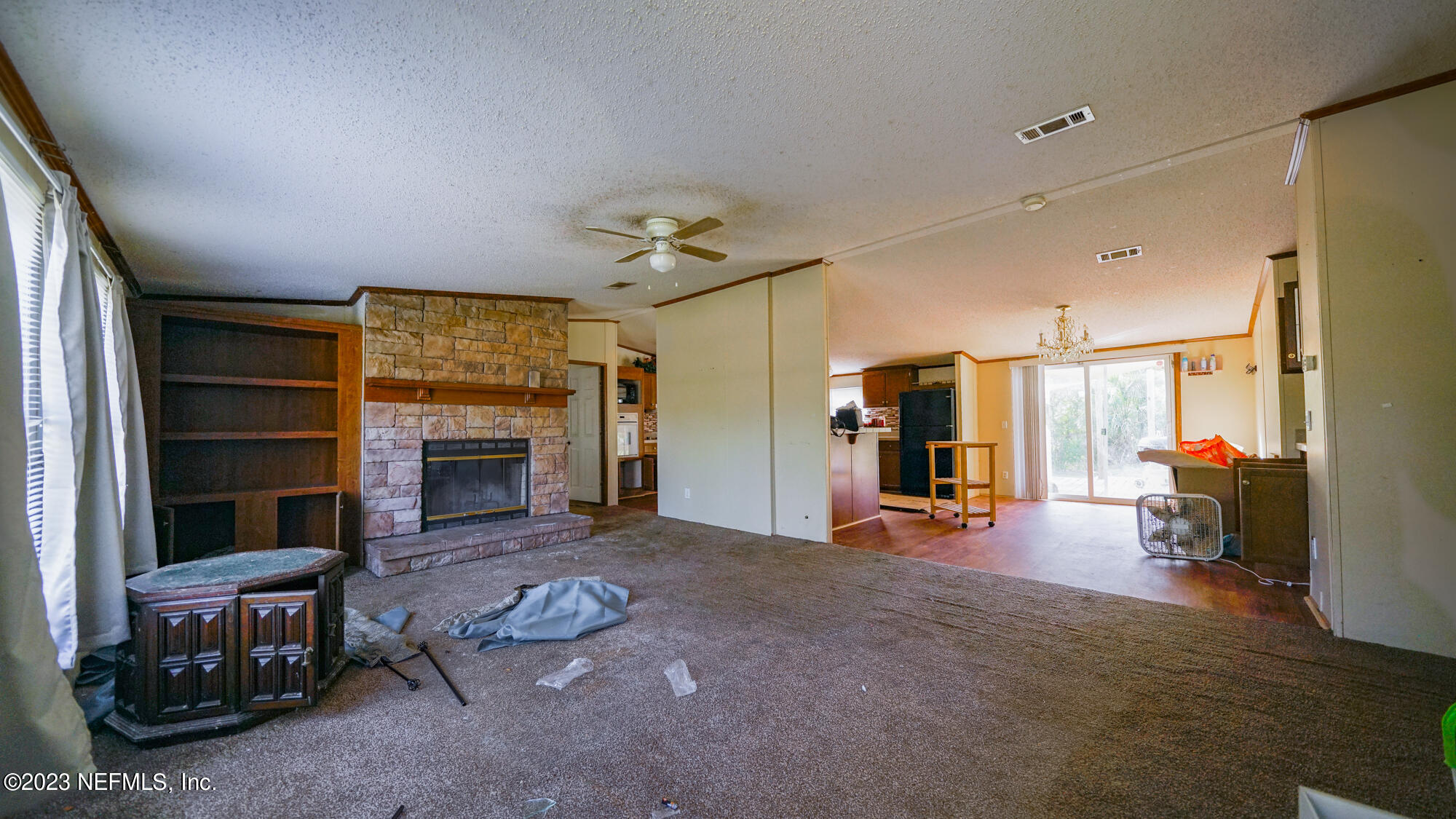 16055 Shellcracker Road Jacksonville, FL 32226 - Photo 4 of 32 a living room with furniture and a fireplace
