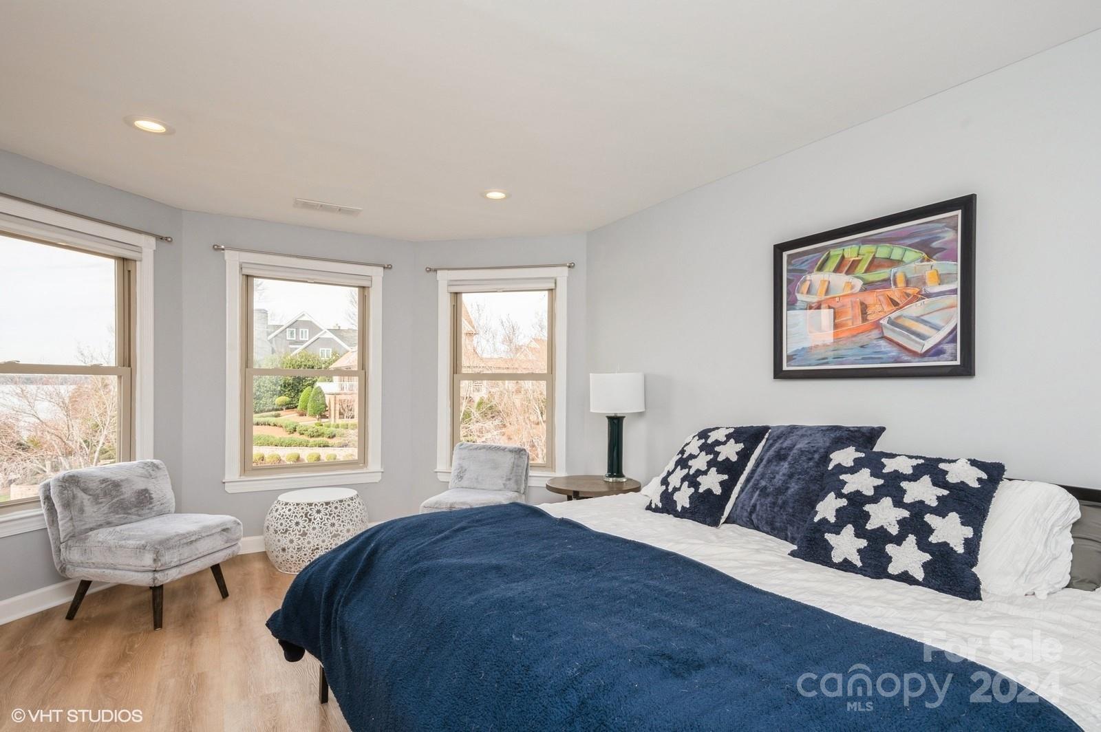 13822 Queens Harbor Road, Unit H Charlotte, NC 28278 - Photo 17 of 37 a bedroom with a bed and wooden floor