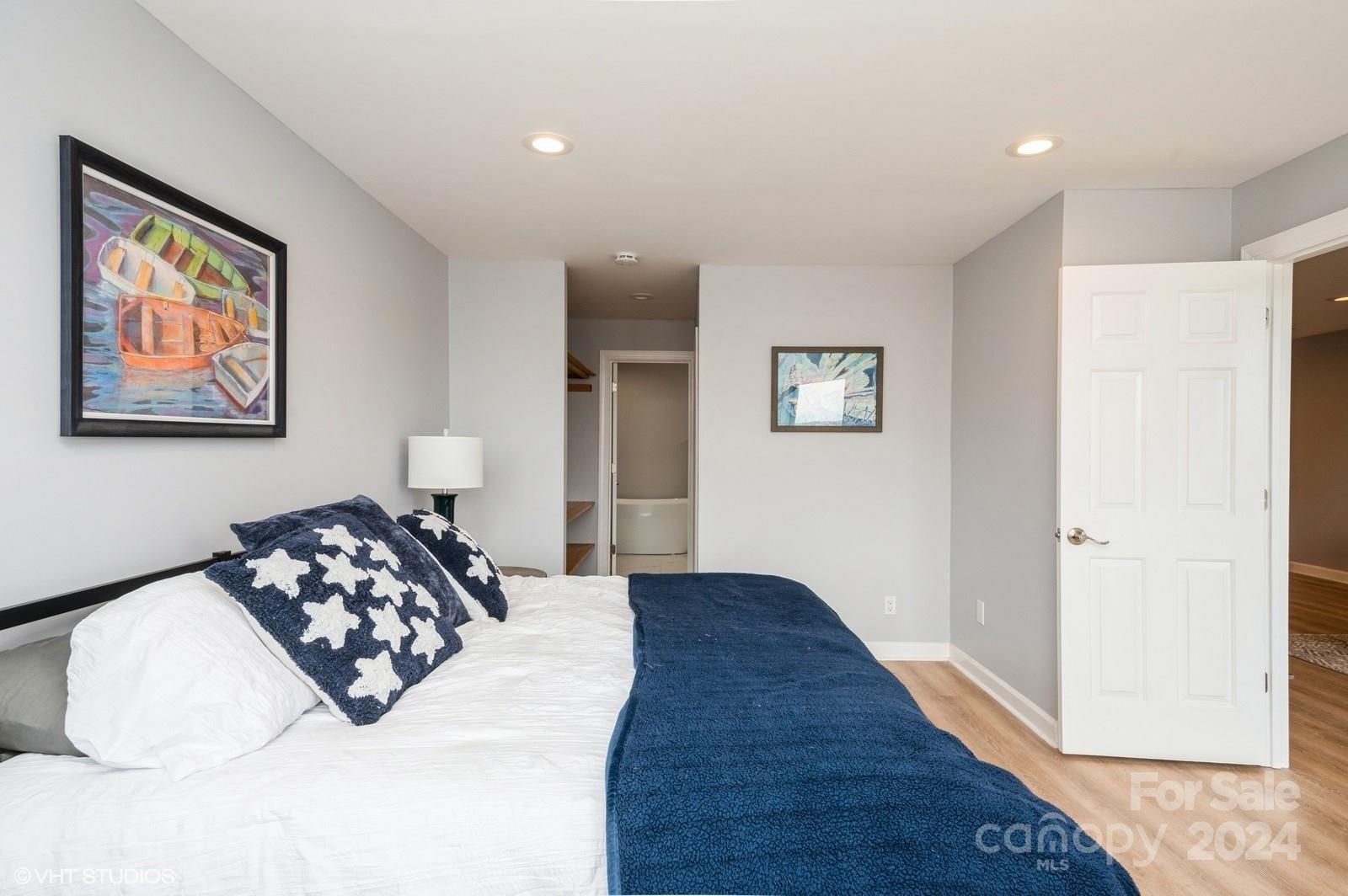13822 Queens Harbor Road, Unit H Charlotte, NC 28278 - Photo 18 of 37 a bedroom with bed and a painting